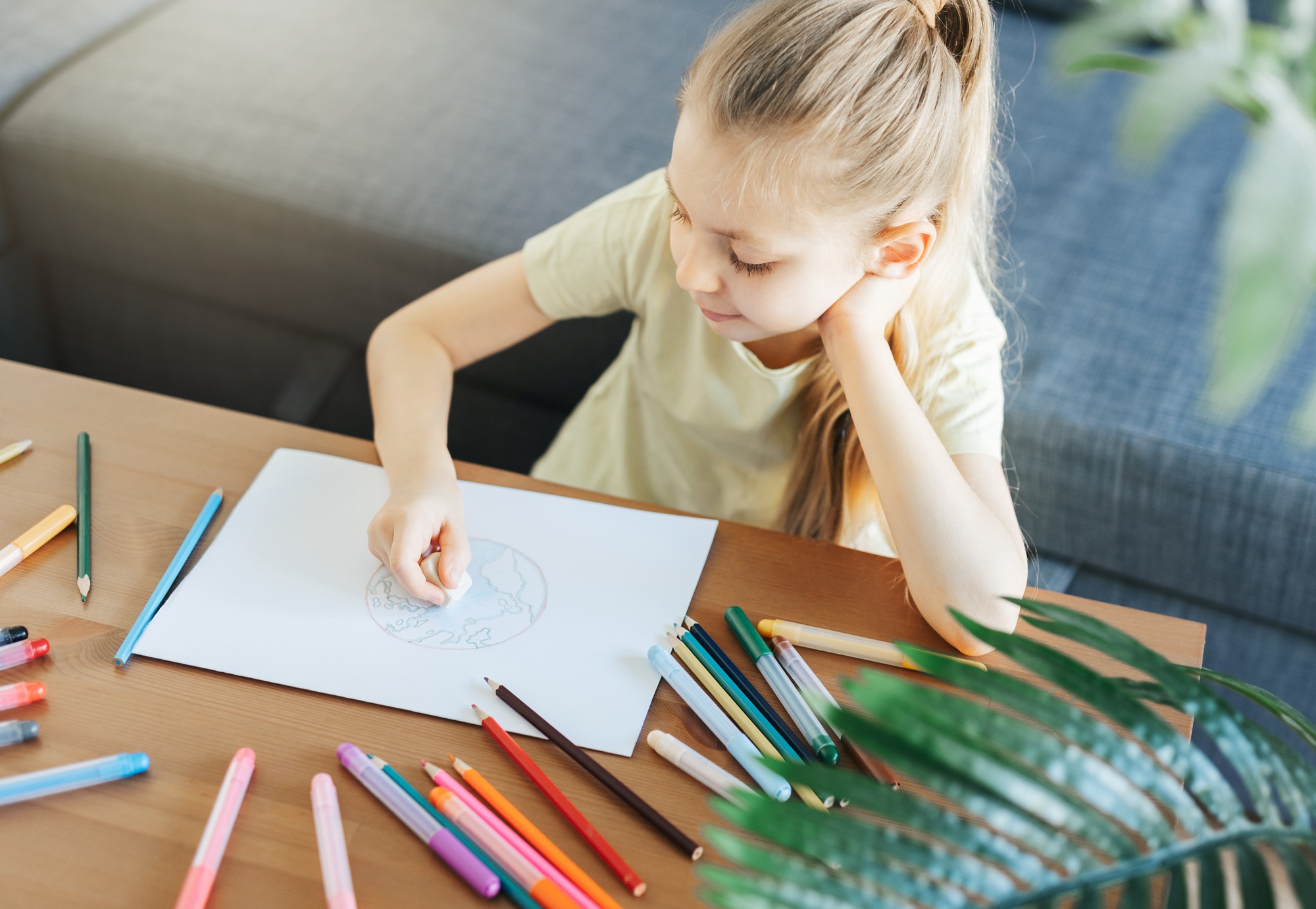Child girl drawing with colorful pencils