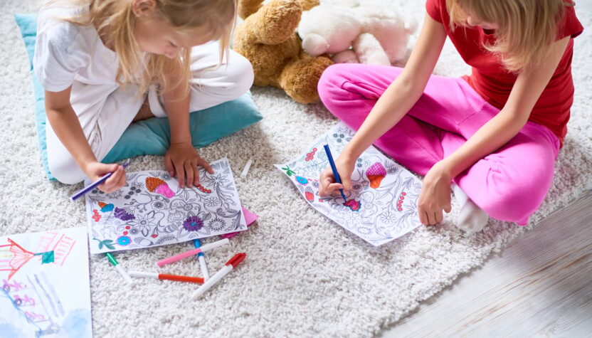 Girls Drawing in Coloring Books on Floor