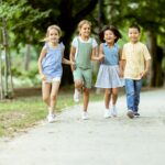 Group of asian and caucasian kids having fun in the park