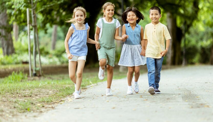 Group of asian and caucasian kids having fun in the park