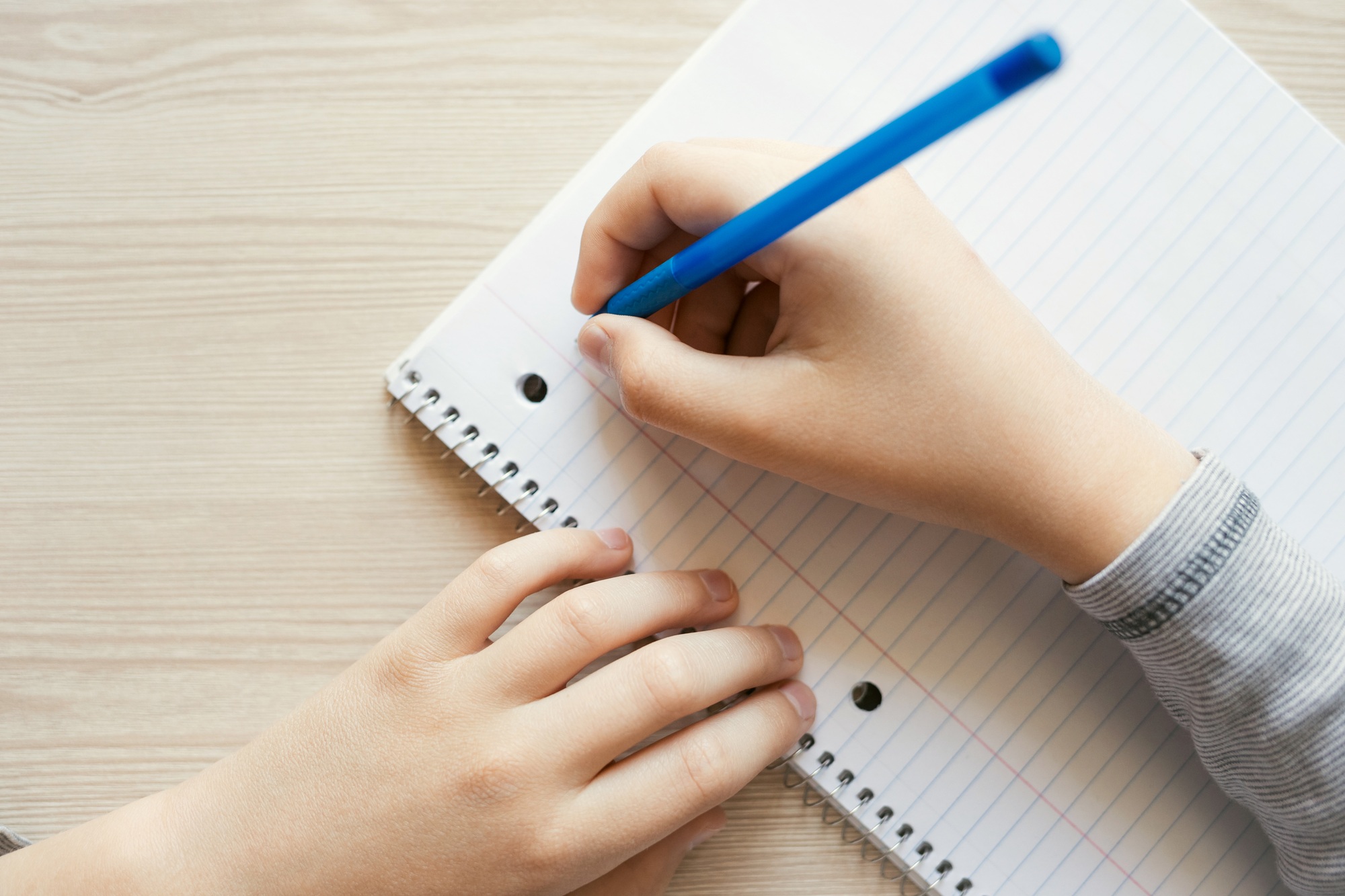 Kid Writing in Notebook.