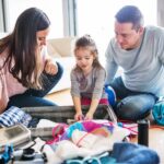Young family with a child packing for holiday.