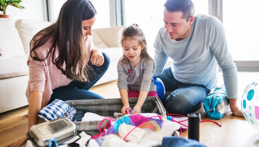 Young family with a child packing for holiday.