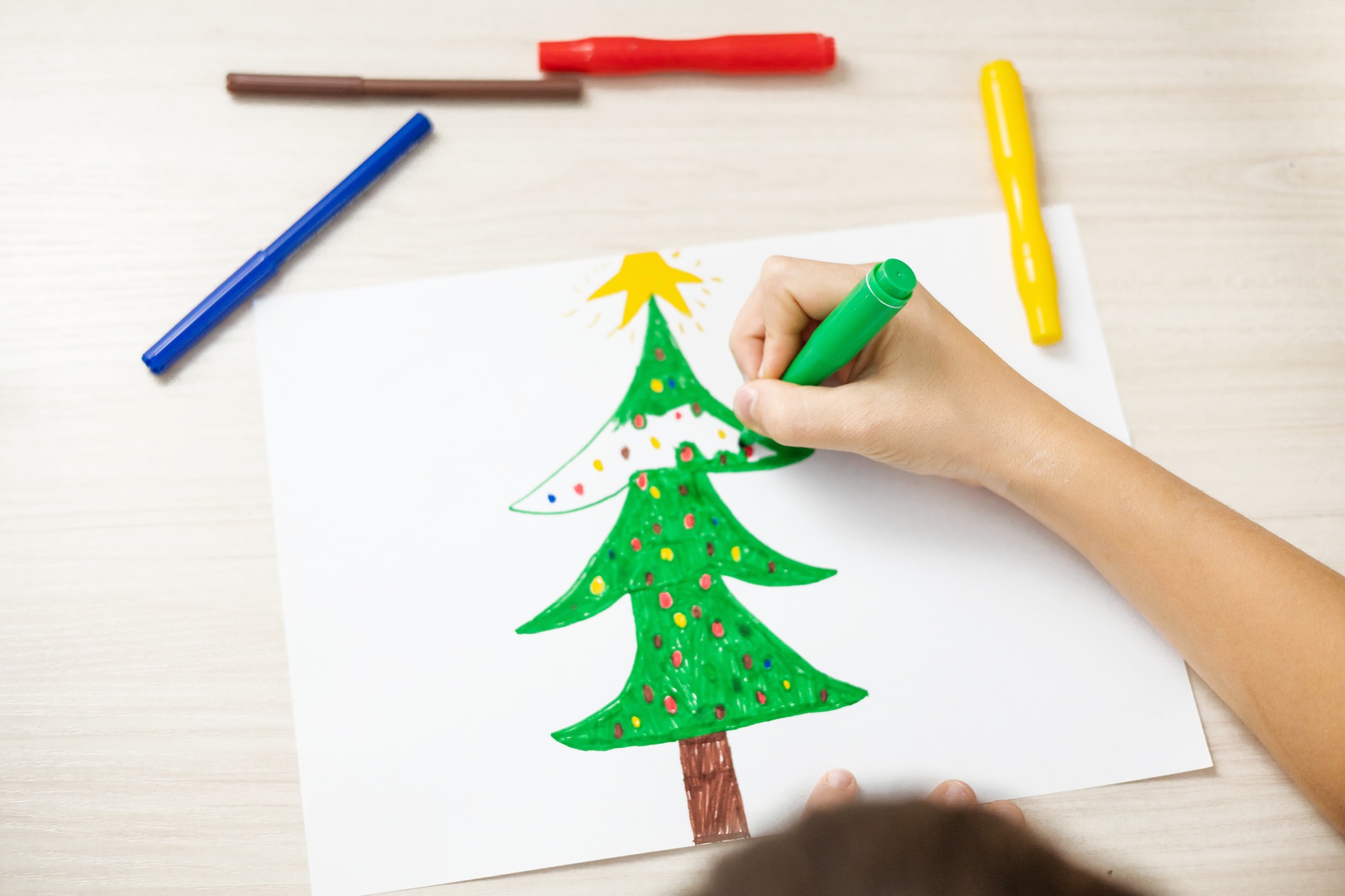 Child draw christmas tree. Christmas holidays