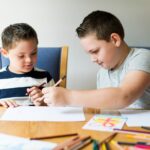 Cute brothers drawing at a table