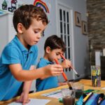 young boys playing with colors and drawing