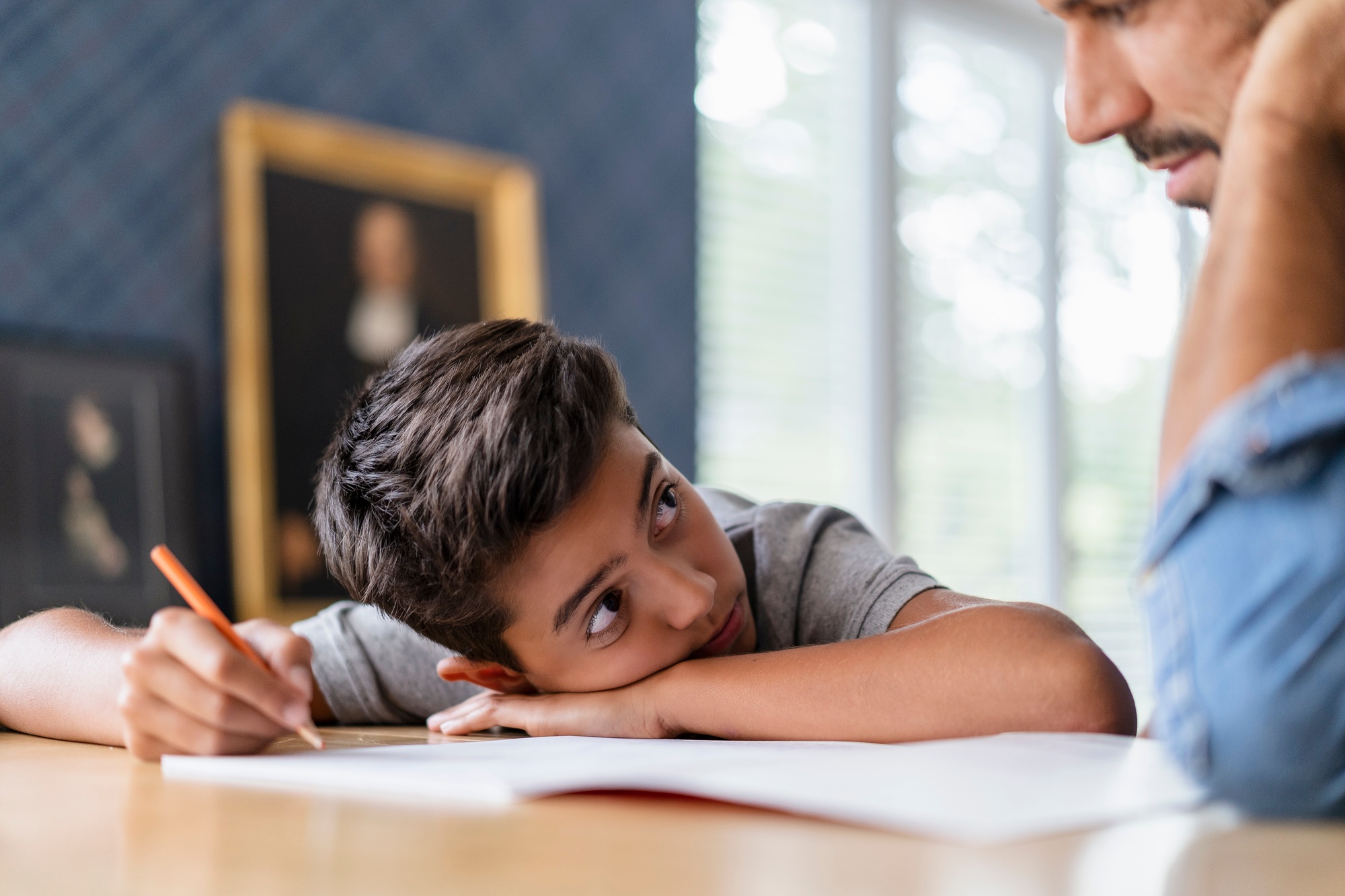 Father helping son doing homework