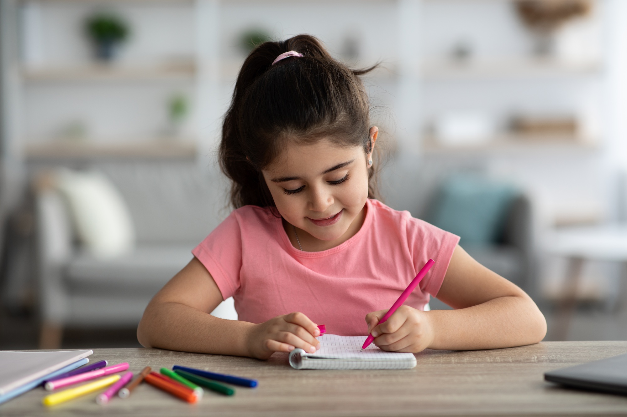Portrait Of Cute Little Preteen Girl Drawing With Colorful Pens At Home