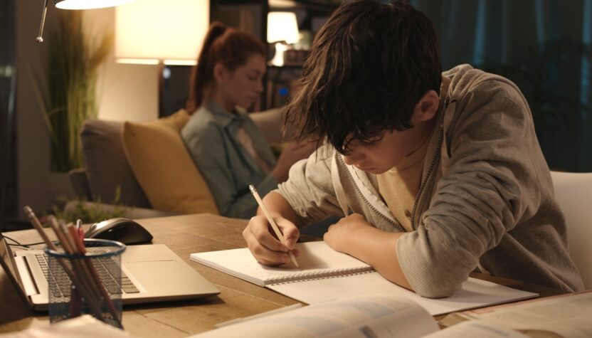 Student doing his homework at home